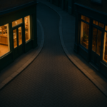 Lit boutique storefronts on a quiet street at night